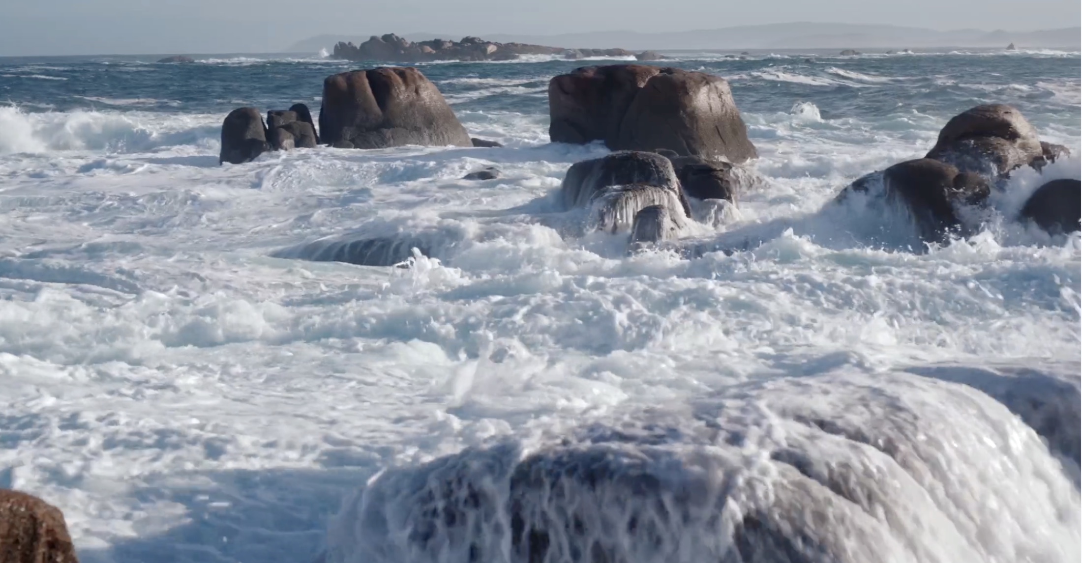 Powerful waves breaking over rocks on the Galician coast